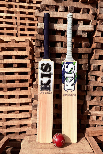 Two cricket bats with 'KIS' branding on a wooden pallet background