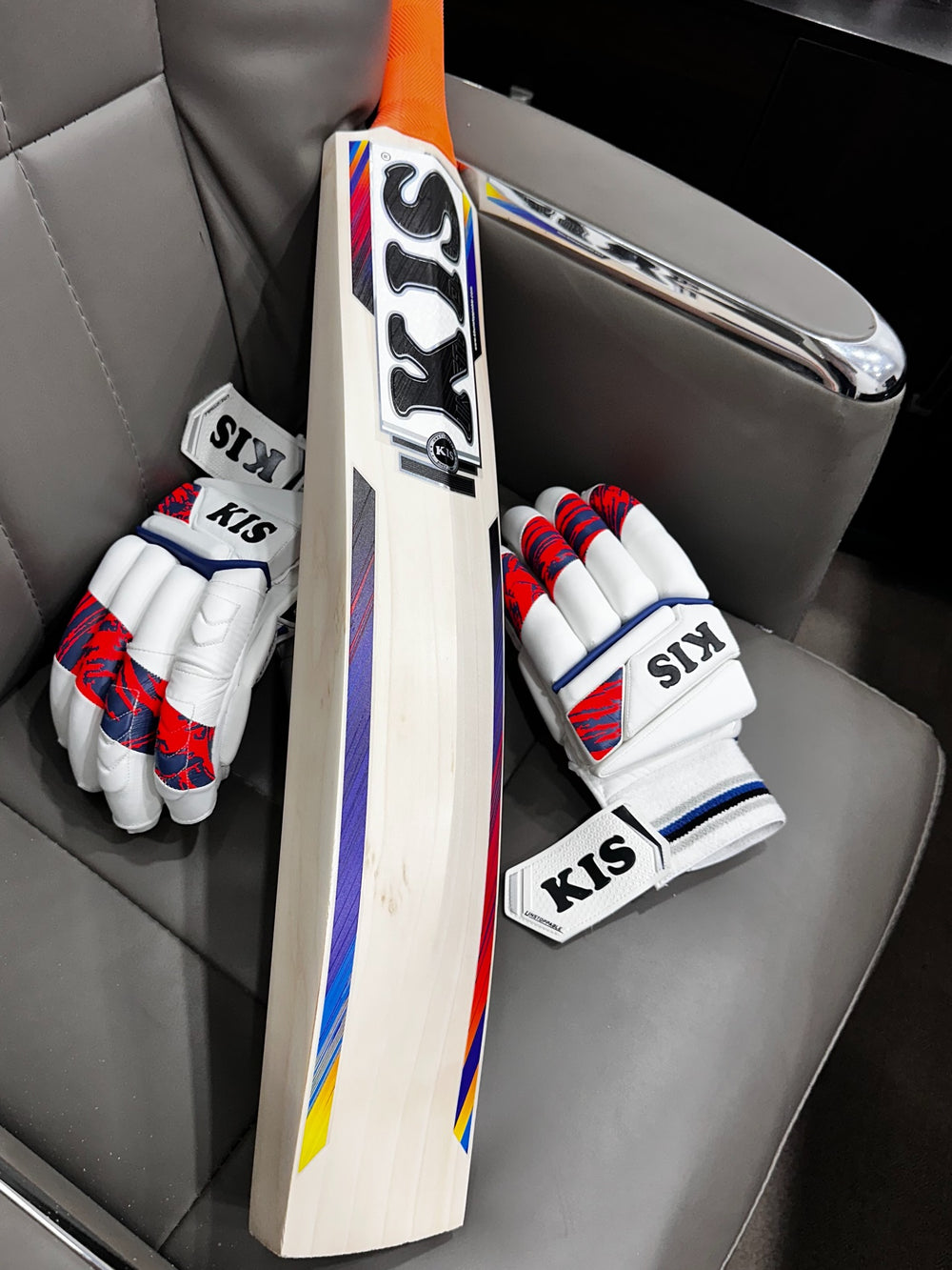 KIS English willow cricket bat and gloves on a car seat